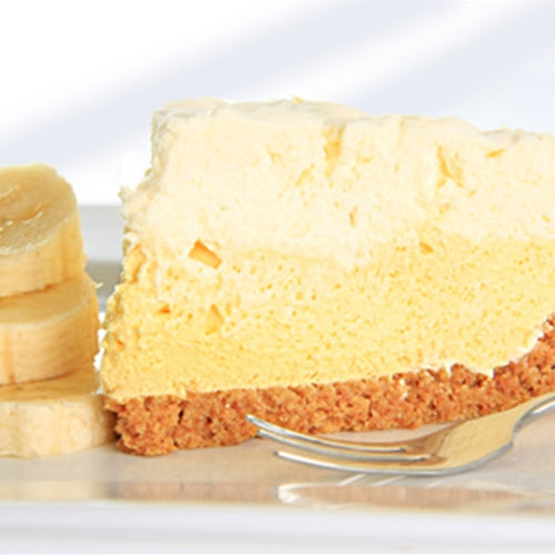 Slice of cheesecake with banana slices on a white plate