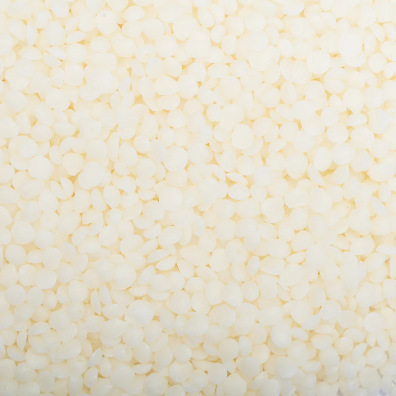 Close-up of small white beads on a light yellow background