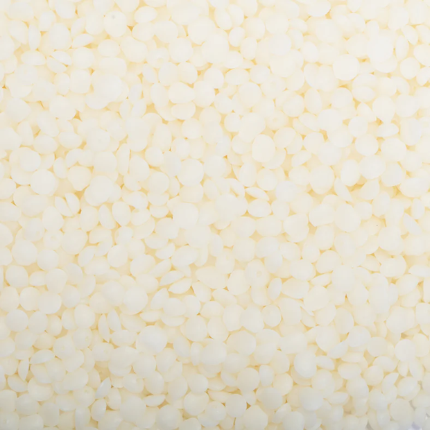 Close-up of small white beads on a light yellow background