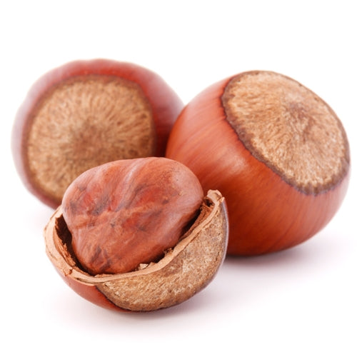 Three hazelnuts with one open on a white background