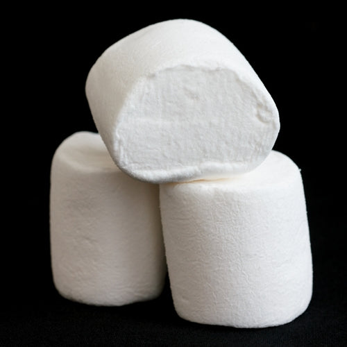Three white marshmallows stacked on a black background