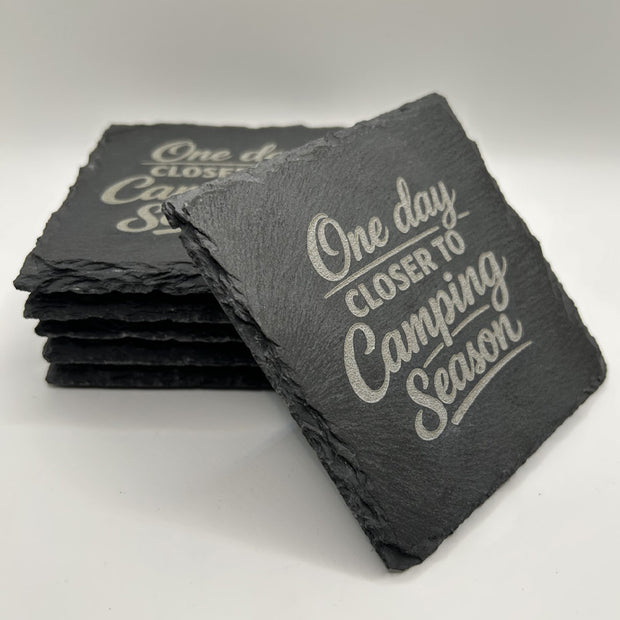 Set of slate coasters with 'One day closer to Camping Season' text on a white background