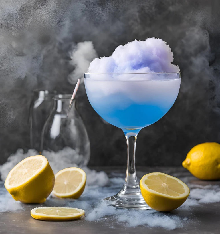 Cotton candy in a glass with lemons on a grey background.