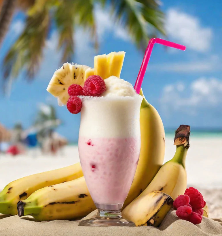 Fruit shake with bananas, raspberries, and a pink straw on a beach.