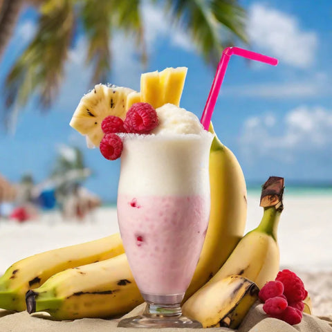 Fruit shake with bananas, raspberries, and a pink straw on a beach.