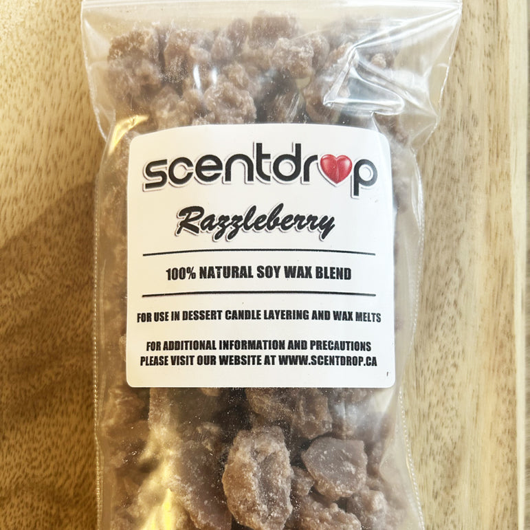 Scentdrop Razzleberry soy wax blend in a clear package on a wooden surface