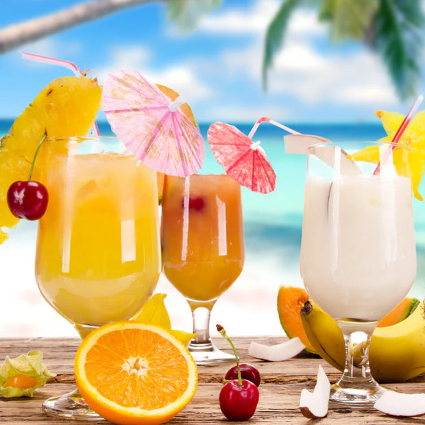 Tropical drinks with fruits on a beach setting