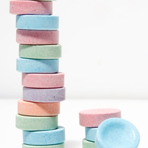 Stack of colorful pastel-colored circular objects on a white background