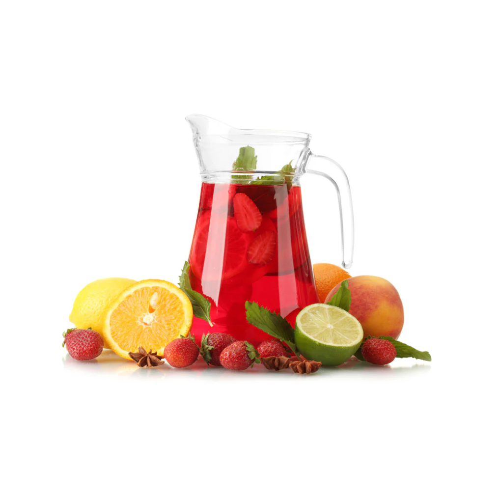Clear pitcher filled with red berry lemonade surrounded by lemons, limes, and strawberries on a white background
