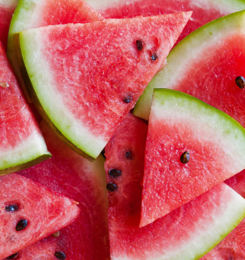 Close-up of sliced watermelon pieces with a bright red flesh and green rind.