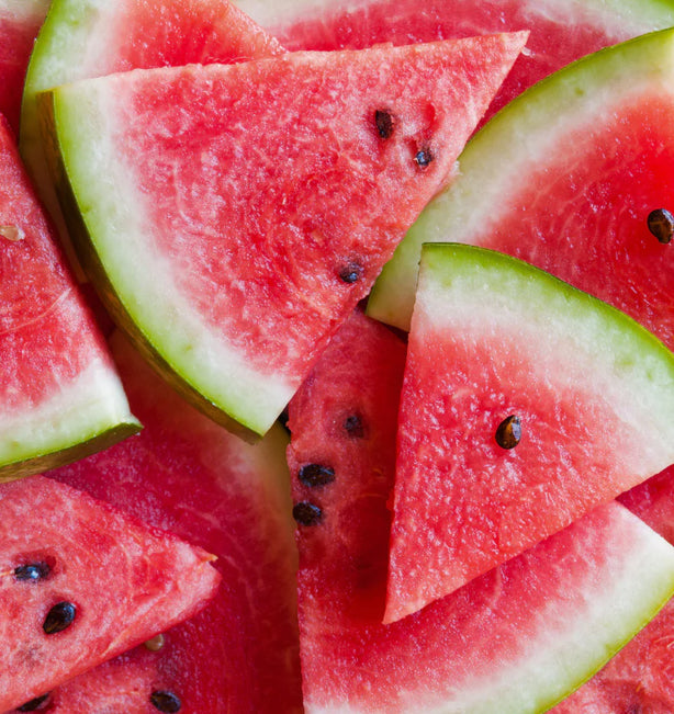 Close-up of sliced watermelon pieces with a bright red flesh and green rind.